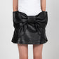 MERADA LEATHER BOW SKIRT IN BLACK